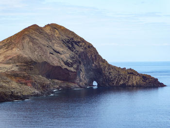 Scenic view of sea and mountains against sky