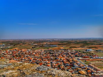 High angle view of cityscape against clear blue sky