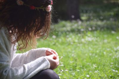 Close-up of girl sitting outdoors