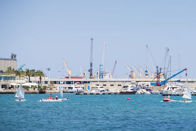 Sailboats in sea against clear sky