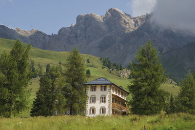 Scenic view of trees and mountains against sky