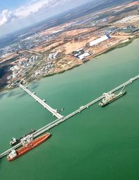 High angle view of commercial dock by sea  against sky