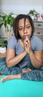 Portrait of a young woman sitting in swimming pool