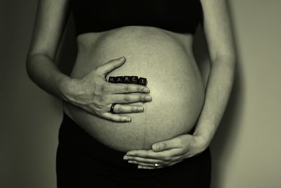 Midsection of pregnant woman standing 