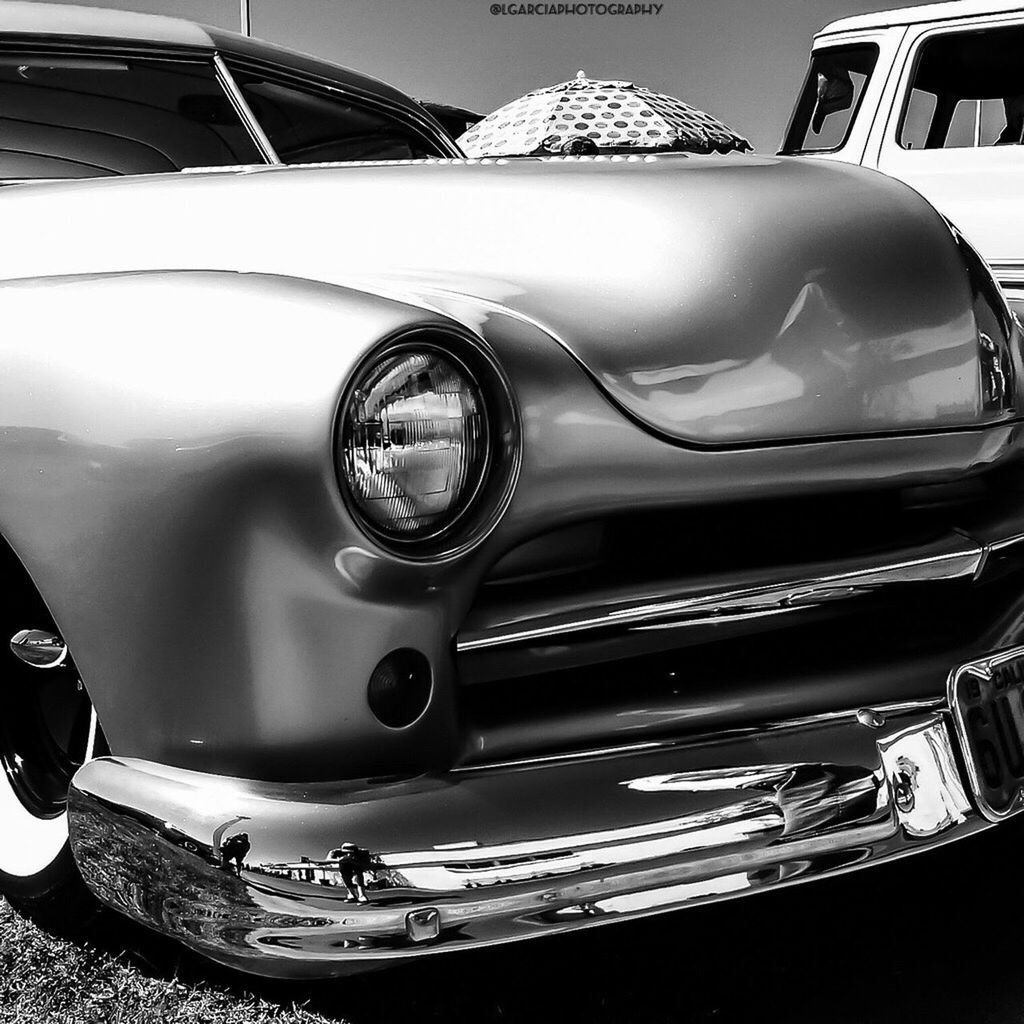 car, retro styled, land vehicle, mode of transport, old-fashioned, indoors, transportation, close-up, vintage car, shiny, part of, technology, vintage, reflection, no people, headlight, still life, stationary, day, high angle view