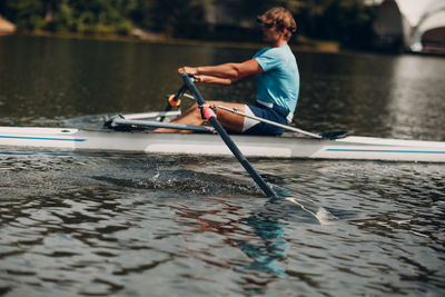 Man surfing on boat in lake