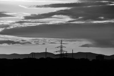 Silhouette landscape against sky during sunset