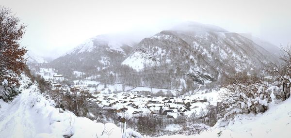 Scenic view of snow covered mountains against sky