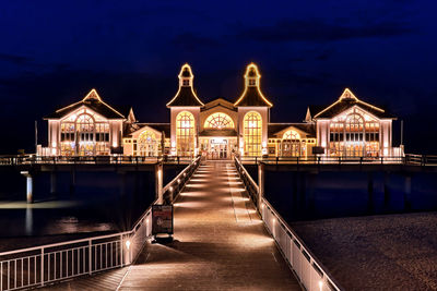 Illuminated building against sky at night