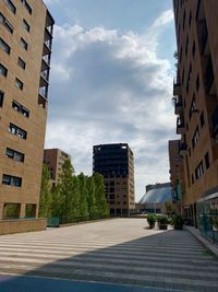 Street amidst buildings in city against sky