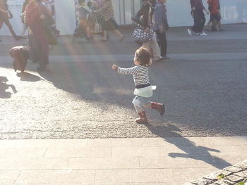 Girl standing on footpath