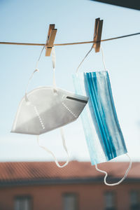 Low angle view of clothes hanging on clothesline against sky