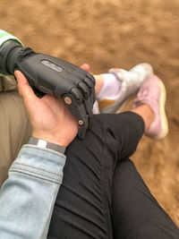 Midsection of woman holding camera