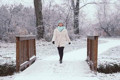 Young woman walking at park during winter