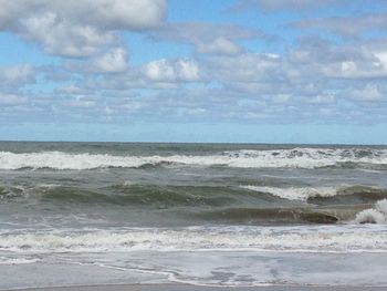 Scenic view of sea against cloudy sky