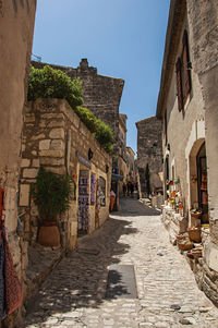Ancient stone houses in alley, in the medieval hamlet of baux-de-provence, france.