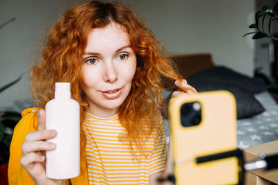 Portrait of young woman using mobile phone