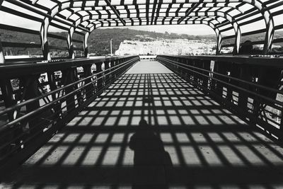 Shadow of railing on footbridge