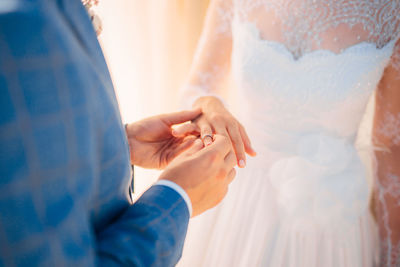 Close-up of hand holding hands against blurred background