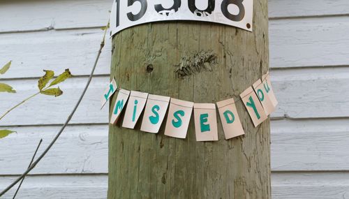 Close-up of text on wooden wall