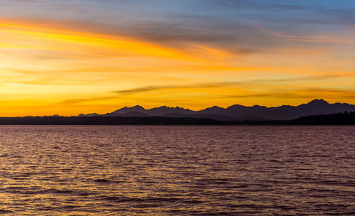 A silhouette shot of a sunset over the olympic mountains in washington state.