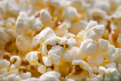 Pile of popcorn closeup macro shot, selective focus, texture background