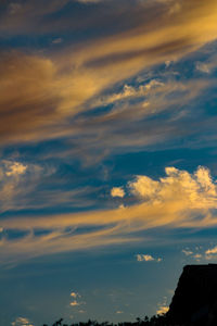 Low angle view of buildings against dramatic sky