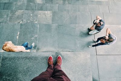 Low section of man and woman wearing shoes