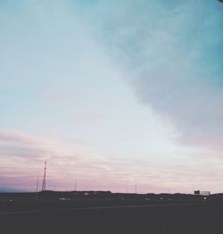 Silhouette of building against cloudy sky