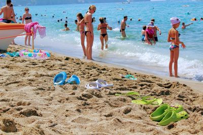 People at beach against sky