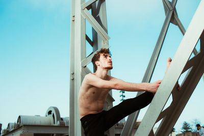 Man exercising on pier over lake