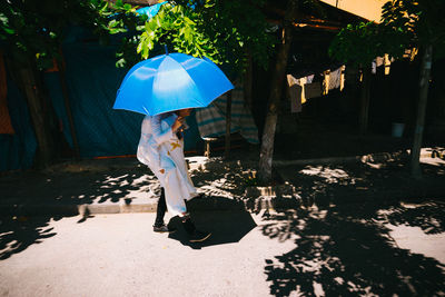 Woman with umbrella walking in rain