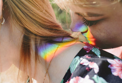 Close-up of lesbian couple with spectrum on body