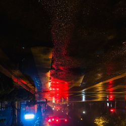 Reflection of illuminated road in water at night