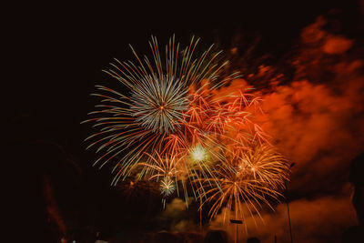 Low angle view of firework display at night
