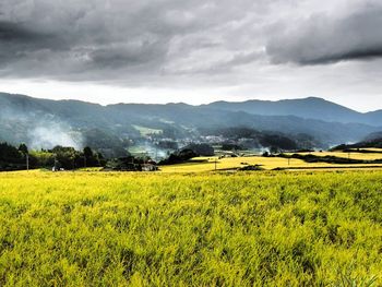 Scenic view of landscape against cloudy sky