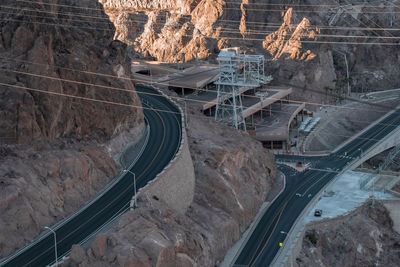 Aerial view of cables over bridge and winding road