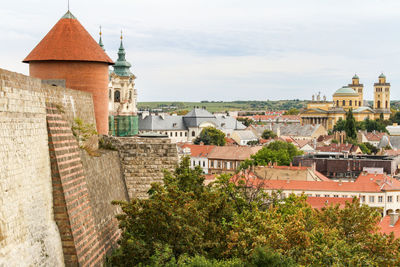 Historic buildings and church against sky