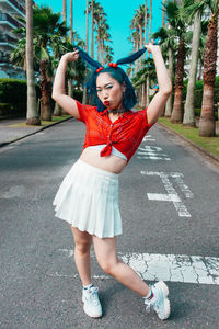 Full length of woman standing on road