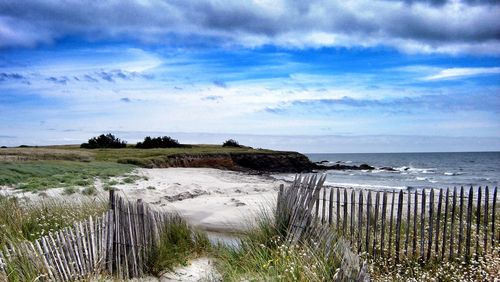 Scenic view of sea against cloudy sky