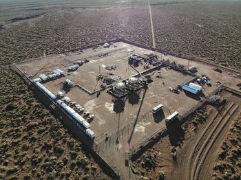 High angle view of vehicles on road amidst field