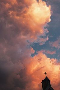 Low angle view of silhouette statue against sky