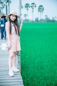 Full length of woman standing on field