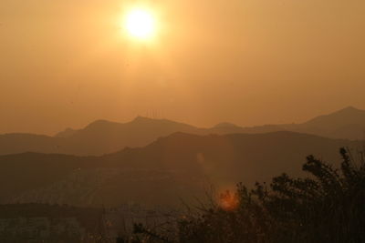 Scenic view of silhouette mountains against sky during sunset