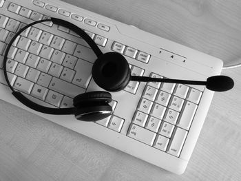 High angle view of headphones on computer keyboard at table