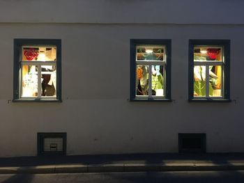 Illuminated building seen through glass window