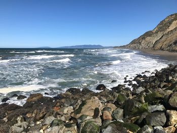 Scenic view of sea against clear blue sky