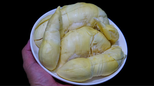 Close-up of hand holding soup in bowl