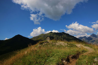 Scenic view of mountains against cloudy sky