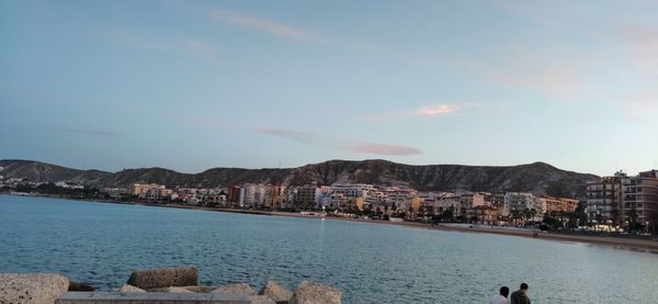 Panoramic view of sea and buildings against sky